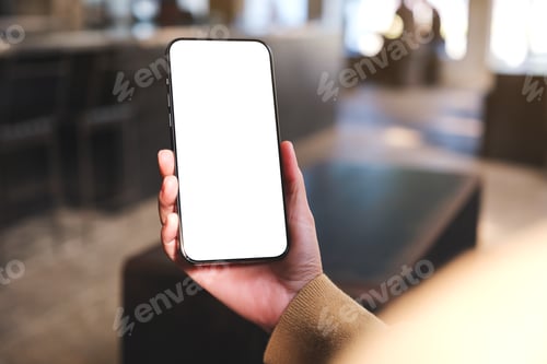 Preview: Mockup image of a woman holding and using mobile phone with blank desktop in cafe