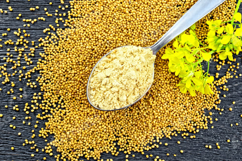 Preview: Mustard powder in spoon with flower on board top