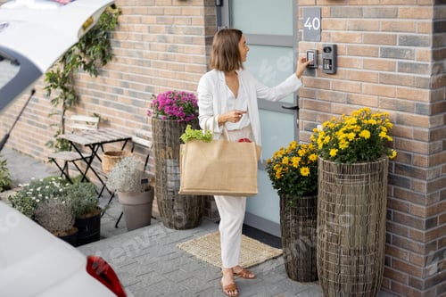 Preview: Woman coming home with groceries and enters a code to access door