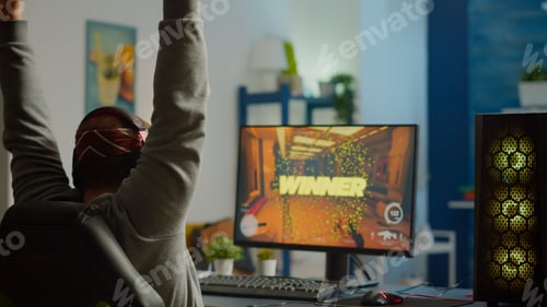 Preview: Back shot of happy man gamer wining first person shooter video game