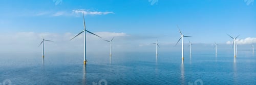 Preview: Drone Aerial view at Windmill park with windmills turbines in the blue ocean