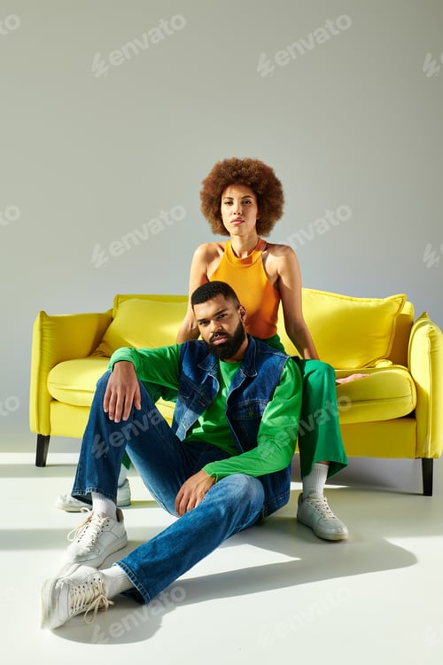 Preview: Vibrant couple relaxing on sunny yellow sofa