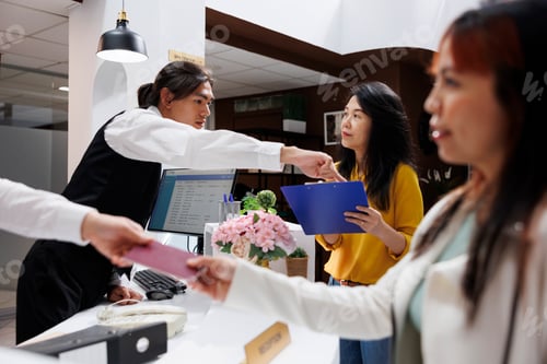 Preview: Hotel staff helps with registration form
