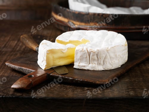 Preview: Sliced Camembert cheese on board