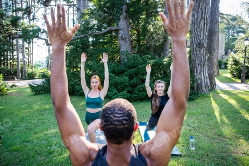 Preview: A group of people are doing yoga in a park, fitness lifestyle