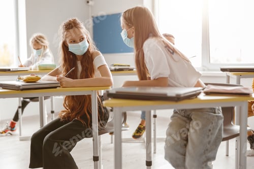 Preview: Kids using pencils and notebooks while writing test together in school