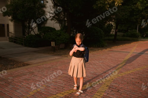 Preview: Happy Little girl from elementary school goes to study outdoor at morning