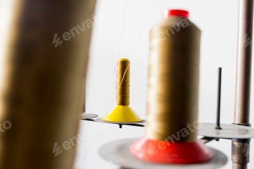 Preview: Golden thread spools in jeans factory