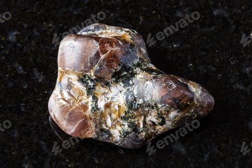 Preview: sample of tumbled andalusite mineral on black