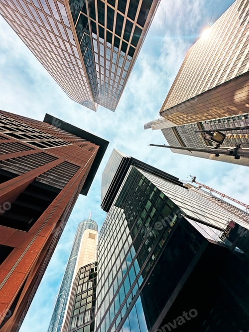 Preview: Tops Of Glass Modern Architecture Buildings From Below on Blue Sky Background In Frankfurt