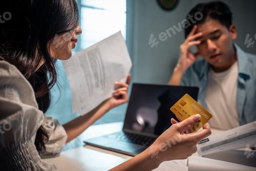 Preview: Asian young depressed couple having argument while checking money debt.