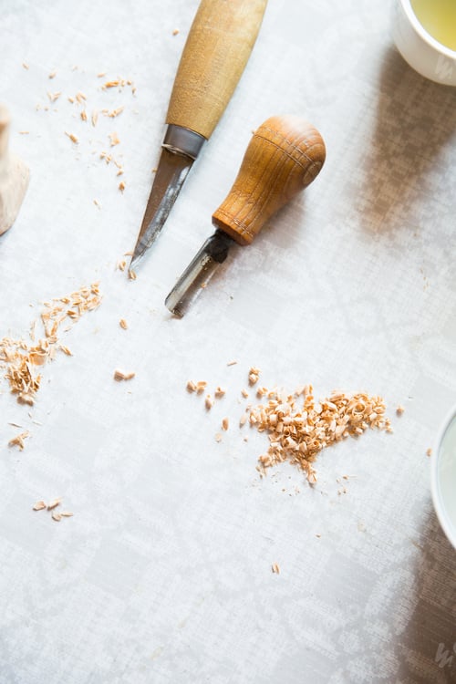 Preview: Wood shavings and carving tools on a tabletop