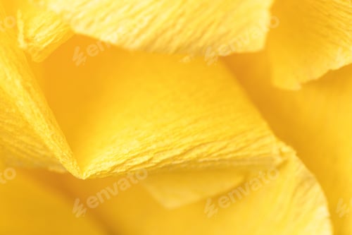 Preview: Fragment of a yellow flower made of crepe paper. Macro photography