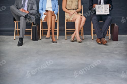 Preview: In the waiting room. Shot of a group of unrecognizable businesspeople sitting in a row.