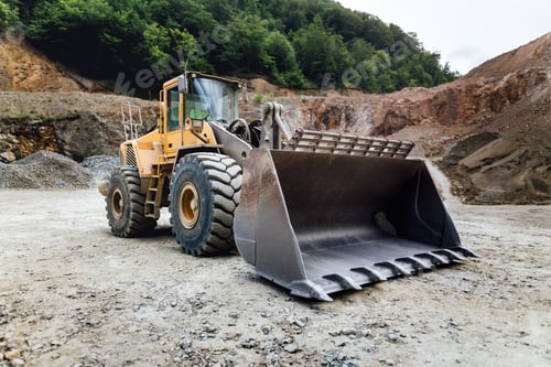 Preview: empty wheel loader machine loading gravel. Industrial machinery working at ore quarry