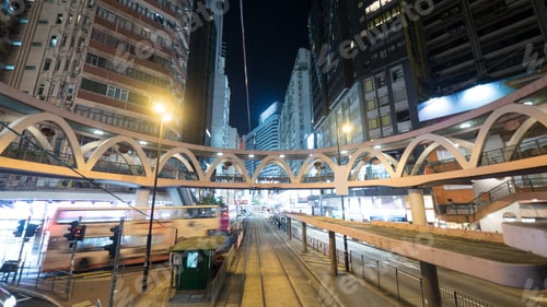 Preview: Illuminated street of Hong Kong with rails and pedestrian bridge