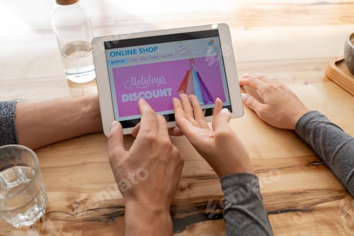 Preview: Hands of young couple pointing at online shop home page on touchpad display