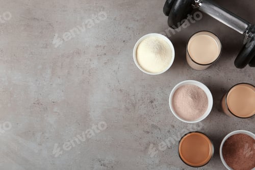 Preview: Flat lay composition with protein shakes in glasses and space for text on table