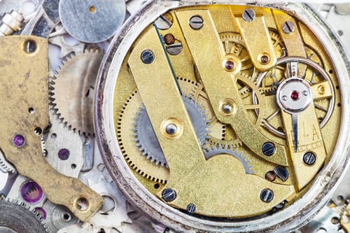 Preview: brass mechanical watch on pile of spare parts