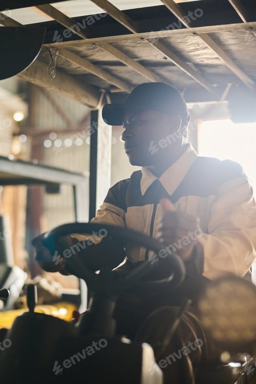 Preview: Male warehouse worker operating on forklift truck