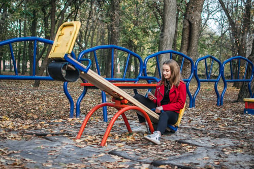 Preview: Gen z, generation z, Zoomers device addiction, digital detox. Teenager girl alone rides on a swing