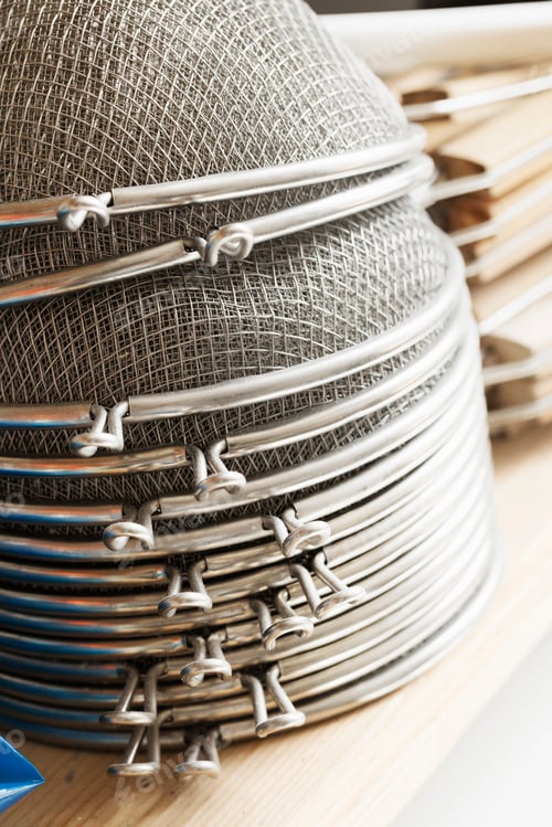 Preview: Close up of a stack of metal sieves.