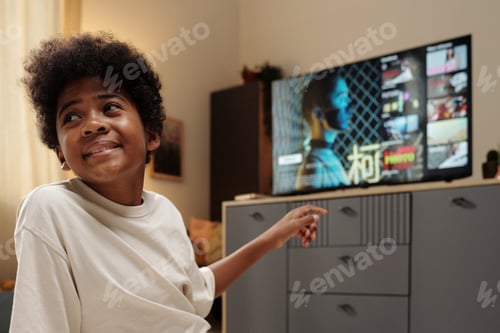 Preview: Smiling Child Watching Television in Cozy Living Room