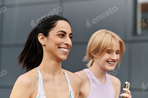 Preview: Two young women share smiles during a joyful outdoor workout on a sunny day