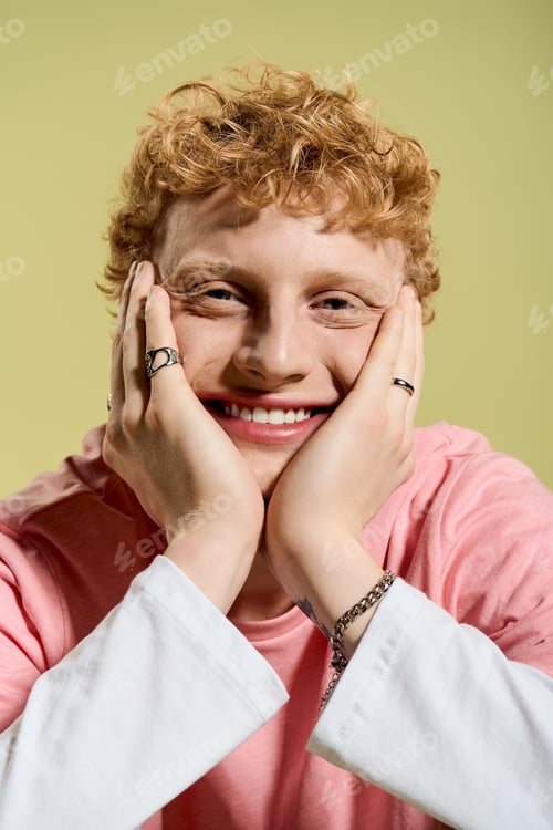Preview: Captured joy of a stylish young man with a charming smile against a vibrant backdrop
