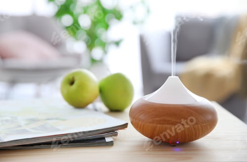 Preview: Aroma oil diffuser on table against blurred background