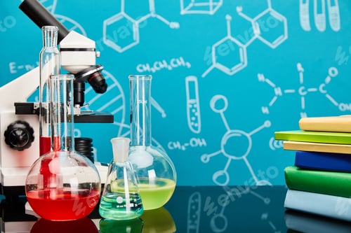 Preview: books, microscope, glass test tubes and flasks with colorful liquid on blue background with