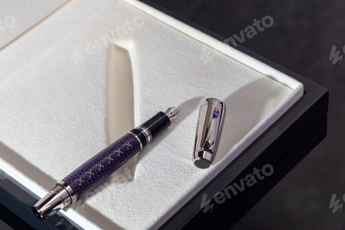 Preview: A signature fountain pen on a gray marble background. A box and case are nearby.