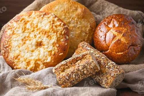 Preview: Round and baguette loafs of whole bread.