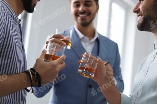 Preview: Group of friends drinking whiskey together indoors