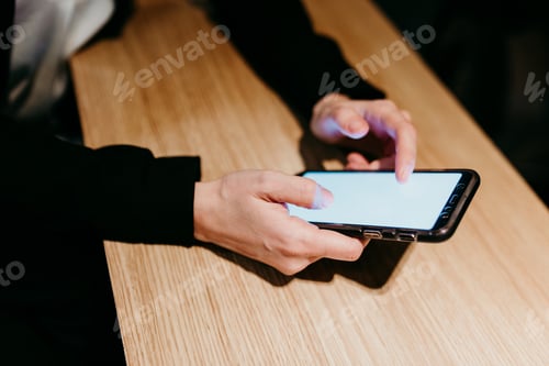Preview: close up view of Unrecognizable woman using mobile phone in a cafe or restaurant. lifestyles