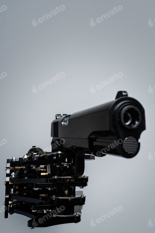 Preview: Real robot's hand with handgun. Concept of AI takeover and technological singularity