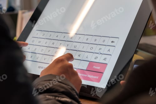 Preview: Tourist hand touching display at self-service transfer machine. buying airplane or train tickets