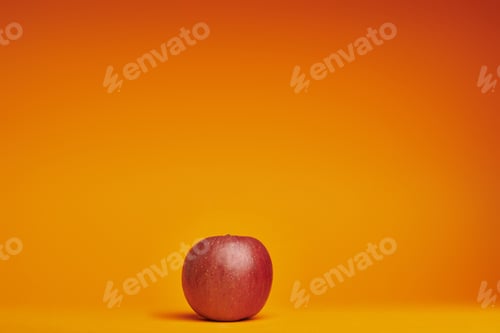 Preview: fresh ripe organic red apple on orange background