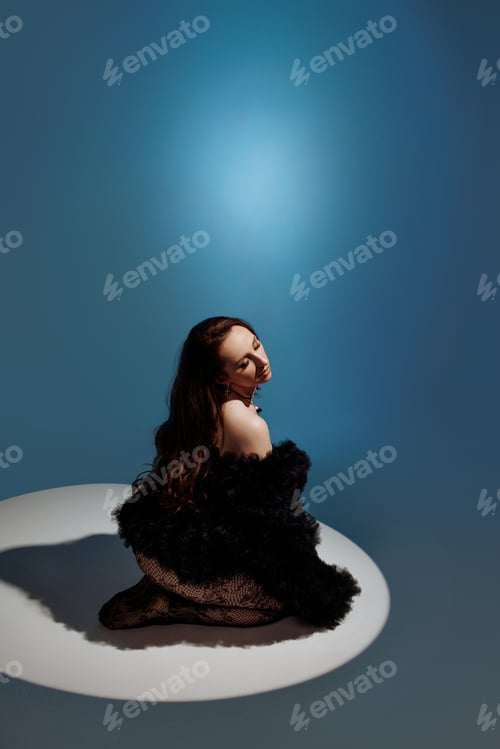 Preview: A woman is sitting on the floor with her legs crossed and her arms crossed