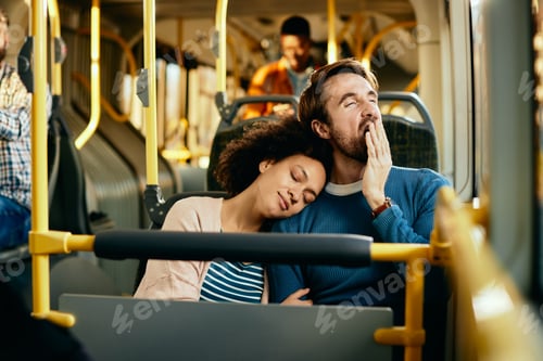 Preview: Exhausted couple commuting together by bus.