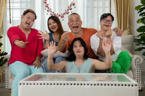 Preview: A family of autistic children are having fun playing board games together by the Christmas tree.
