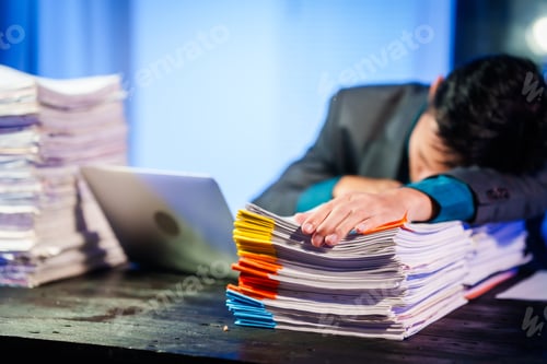 Preview: An Asian young businessman sit his desk late night,exhausted from overtime work.Resting his eyes