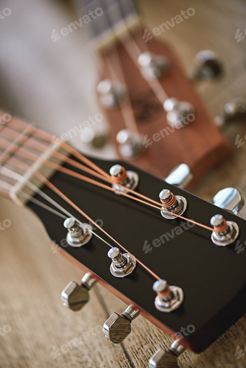 Preview: Uppermost part of the guitar. Vertical close up photo of guitar necks with tuning keys for adjusting