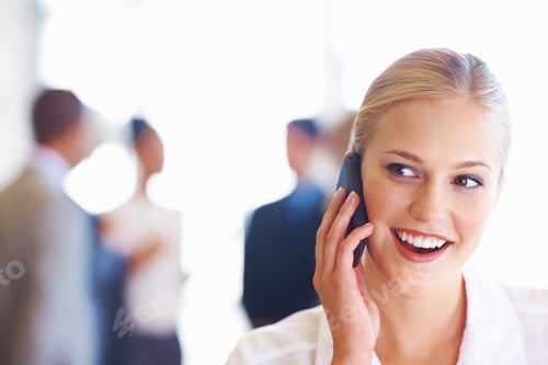 Preview: Closeup of cute female executive on phone call with business team in background