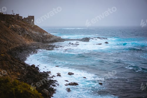 Preview: Bluff volcanic coastline in Sinagoga with stormy atlantic ocean. Trekking trail from Ponta do Sol to