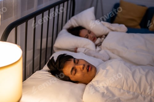 Preview: Asian woman feel frustrated from husband snoring while sleep at night.
