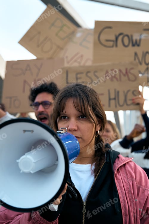 Preview: Woman with megaphone in protest group activist people demonstrate together shouting against wars.