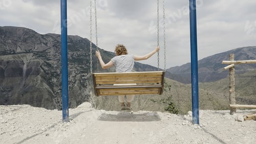Preview: Nature with swings near the mountains. Action. Beautiful people enjoy the scenery of wonderful
