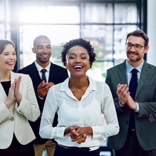 Preview: Portrait of a succesful businesswoman being applauded by her colleagues in the office