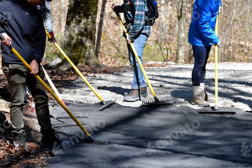Preview: Doing community service by spreading gravel with rakes and shovels and other hand tools on pathways.